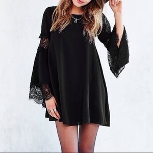 Black bell sleeved dress with lace detail